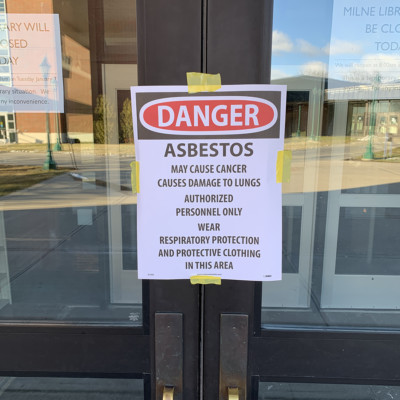 Sign at entrance of Milne Library Building announcing that the building is Closed due to Asbestos Sign at entrance of Milne Library Building announcing that the building is Closed due to Asbestos