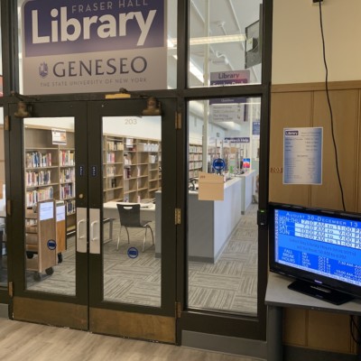 Fraser Hall Library interior entrance with sign and digital display, summer 2021 Fraser Hall Library interior entrance with sign and digital display