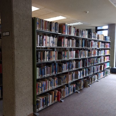 Books flagged with blue painter tape for retrieval from the Milne Library Building, Summer 2020 Books flagged with blue painter tape for retrieval from the Milne Library Building, Summer 2020