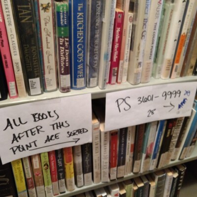 One of many signs on the book stacks noting which books are left to be sorted and which ones are completed PS section with signs noting which books are left to be sorted and which ones are completed