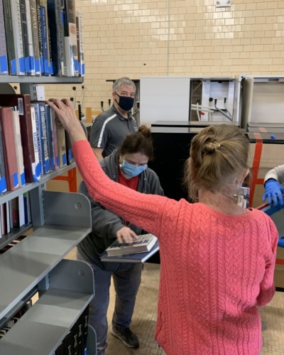 Hoffman, Argentieri, Hanna sorting flagged books in Schrader, Spring 2021 Hoffman, Argentieri, Hanna sorting flagged books in Schrader, Spring 2021