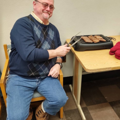 Finnigan cooking sausages for Facilities Thank You breakfast